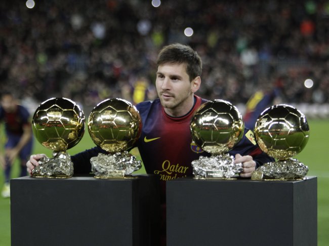 Messi Poses with His Ballon d'Or Awards 