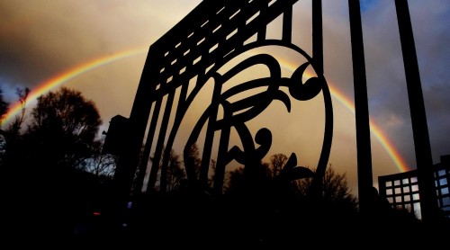 A rainbow forms behind the silhouetted gates of Murray Park, Rangers' training ground