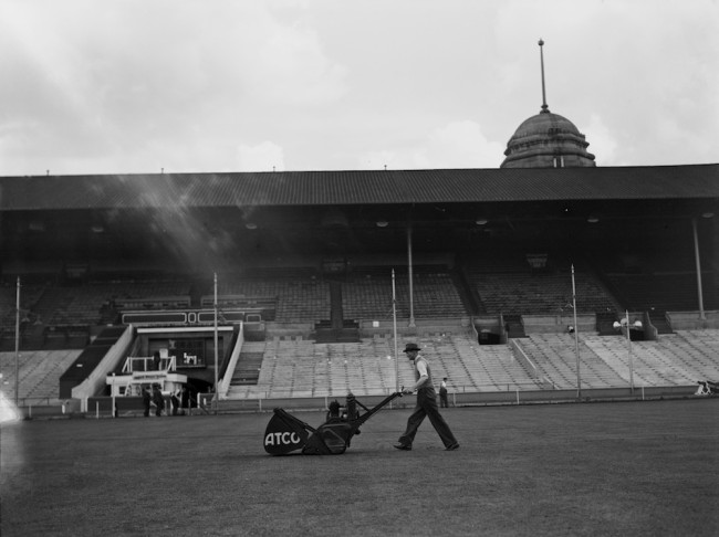 A groundsman mowing the pitch in preparation for the FA Cup final at Wembley Stadium, London, 29th April 1939. (Photo by H. F. Davis/Topical Press Agency/Hulton Archive/Getty Images)
