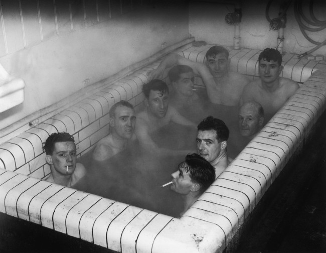 Ipswich Town football players having a bath together at Portman Road after the replay of their third round FA Cup match with Aston Villa, 11th January 1939. Villa won the tie 2-1  (Photo by London Express/Getty Images)