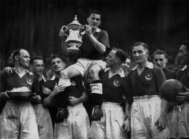 5th June 1939:  Jimmy Guthrie, the Portsmouth captain, being carried by his team mates after winning the FA Cup final.  (Photo by Keystone/Getty Images)