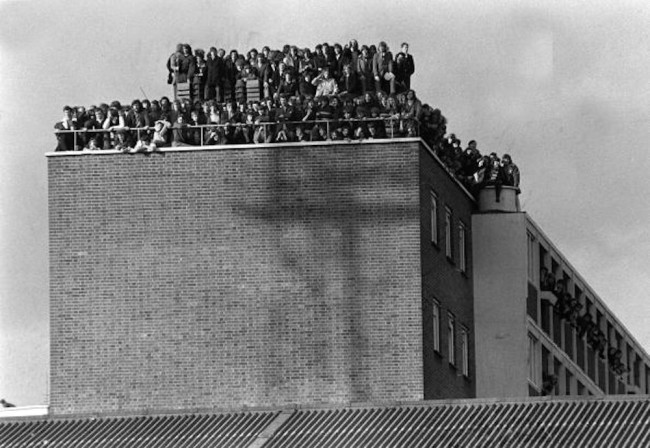 Sport, Football, London, England, 14th February 1972, Fans crowd the roof of a block of flats overlooking West Ham's Upton Park pitch as the Hammers win their FA Cup replay v Hereford 3-1  (Photo by Popperfoto/Getty Images)