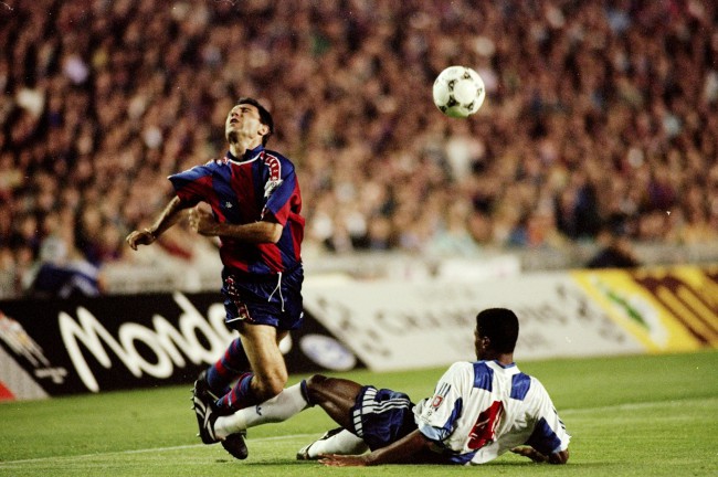 27 Apr 1994:  Hristo Stoichkov (left) of Barcelona is brought down during the European Cup semi-final against FC Porto at the Camp Nou Stadium in Barcelona, Spain. Barcelona won the match 3-0.  Mandatory Credit: Shaun  Botterill/Allsport