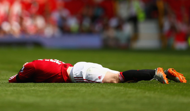 MANCHESTER, ENGLAND - AUGUST 08: Wayne Rooney of Manchester United lies on the ground during the Barclays Premier League match between Manchester United and Tottenham Hotspur at Old Trafford on August 8, 2015 in Manchester, England.  (Photo by Clive Brunskill/Getty Images)