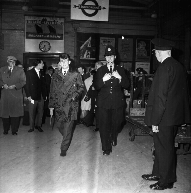 Preston Football Club's Howard Kendall, being escorted through a train station, in the city for his teams match at Wembley Stadium, London, April 1964. (Photo by Kaye/Express/Getty Images)