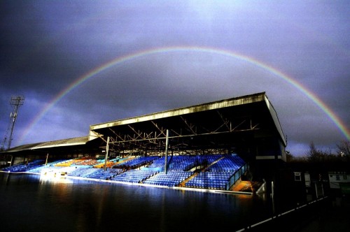 A rainbow forms over the stands at a flooded Gay Meadow, home of Shrewsbury Town